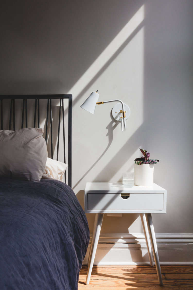 The palette shifts to paler shades upstairs. The master bedroom, shown here, is  in Benjamin Moore Picket Fence. Says Andrea: &#8