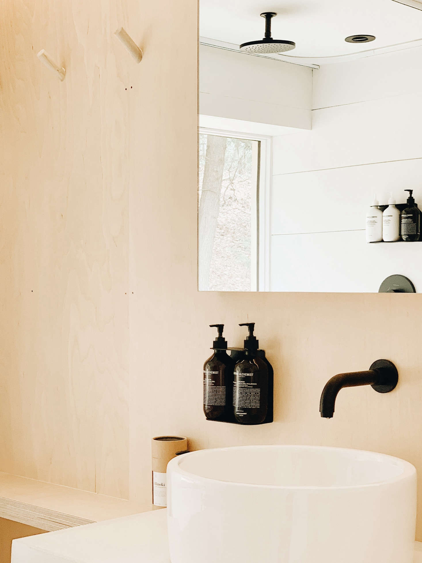 The house is stocked with Hand Soap and other toiletries by Grown Alchemist, neatly hung on black metal Soap Dispenser Holders from DesignStuff of Australia. (Amazon offers the similar Ceremony Home Wall-Mount Soap Dispenser with Glass Bottle.)