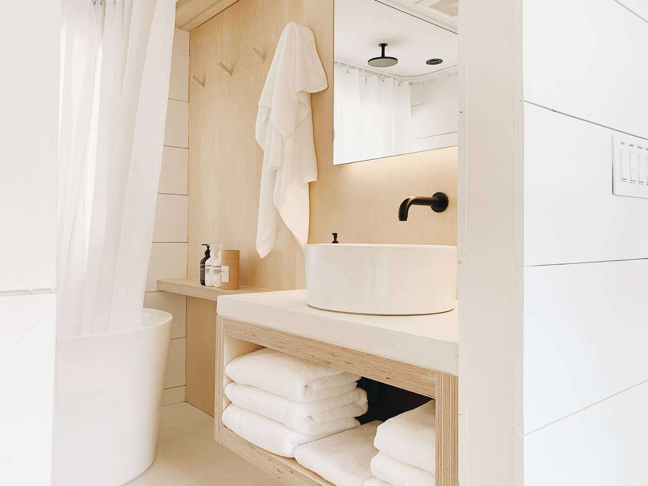 The plywood continues in the streamlined bathroom.