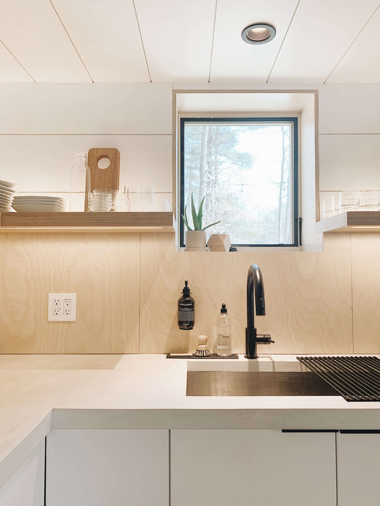 Concrete counters frame an undermount sink with the couple