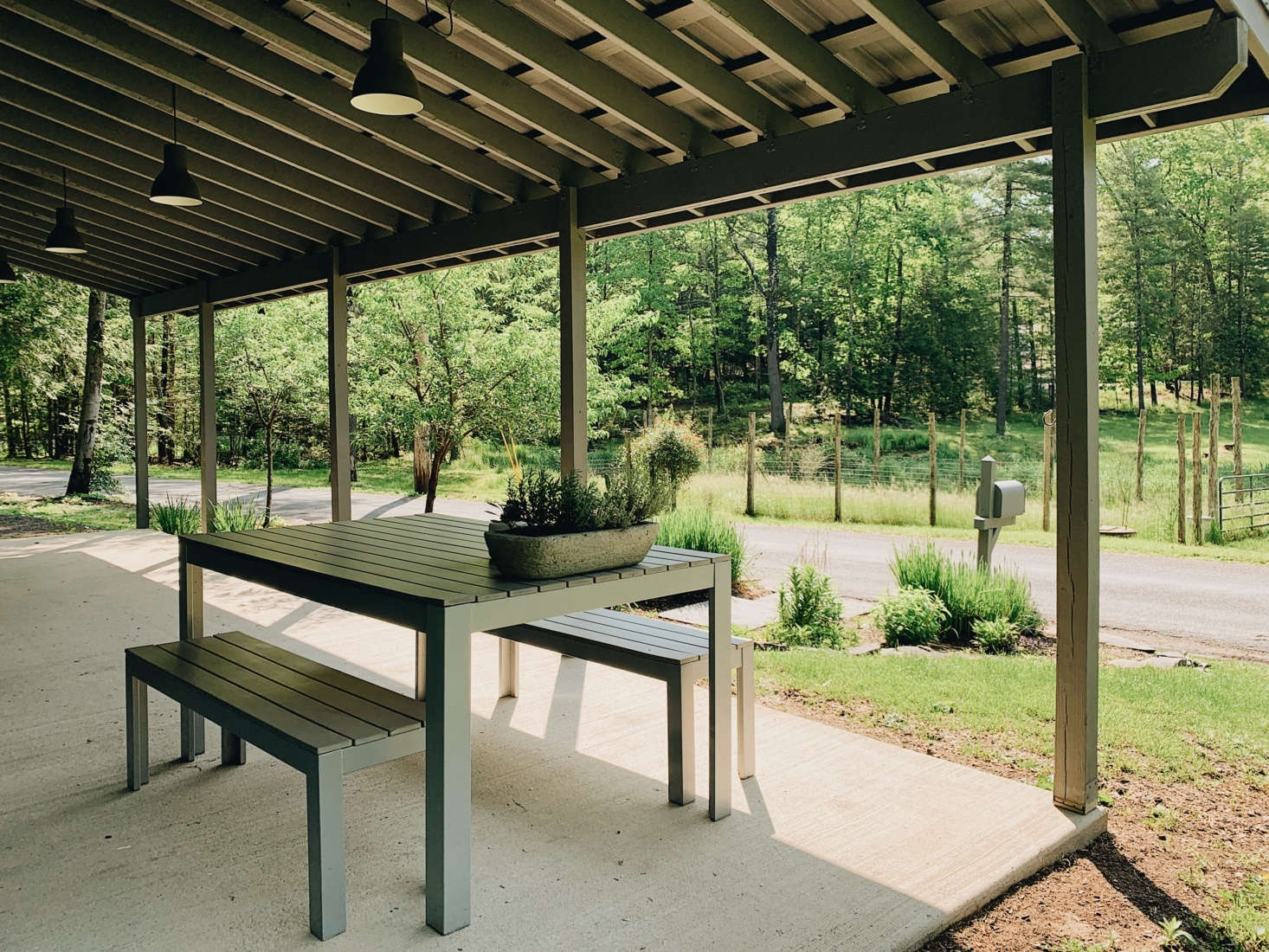 The Cook House is set up for easy meals, indoors and out. The table and benches are a discontinued Ikea design.