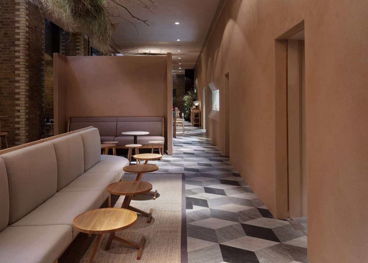 The restaurant is divided into three sections—a bar/lounge area (pictured here), the main dining room, and a private dining area. The original tiled marble floors, laid out in an arresting graphic pattern, remain; while it