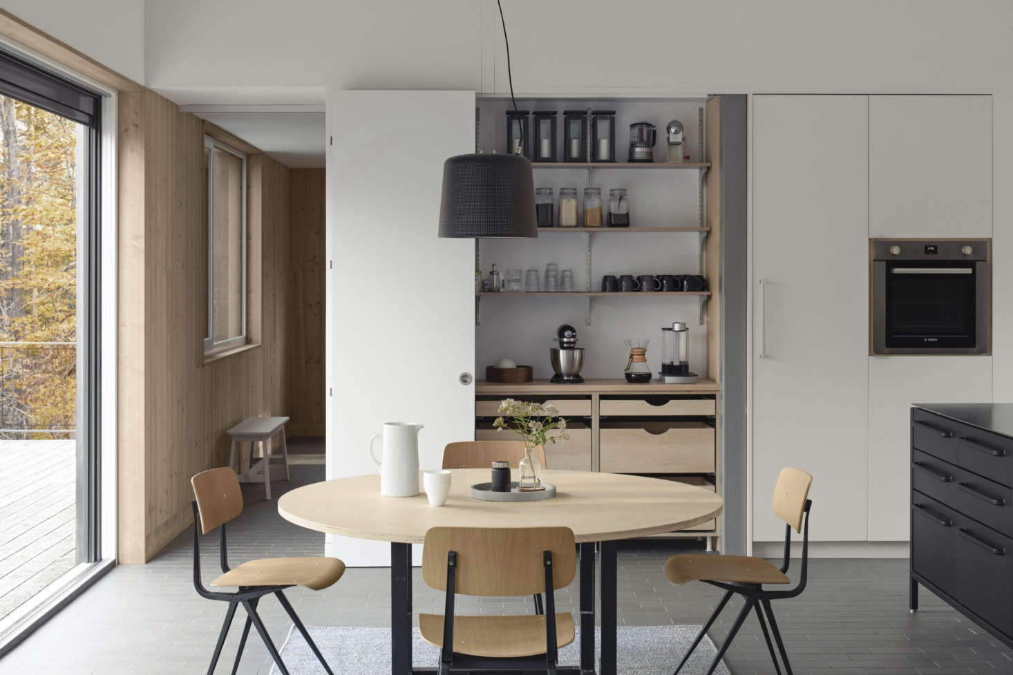 The table stands next to a built-in pantry with drawers of unfinished birch ply and white doors. It, too, came from CabParts, 