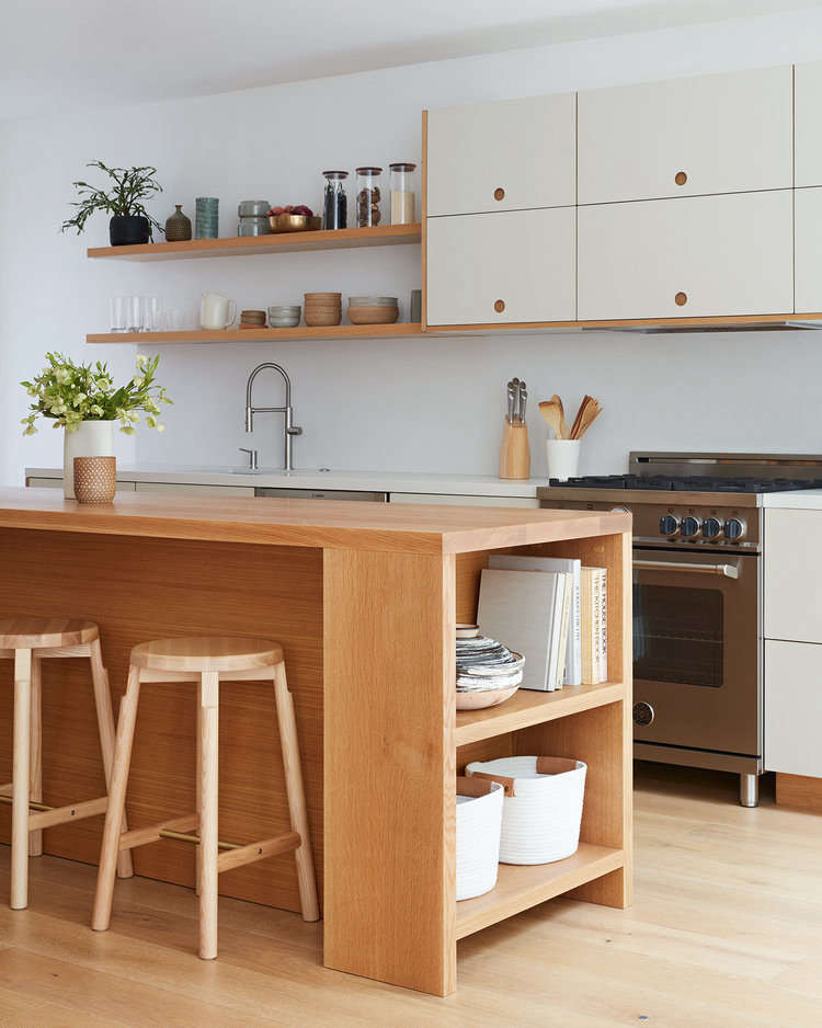 The cabinets are made up of Ikea frames with fronts from the Basis line by Reform. Displayed on the open shelves are some of Amy