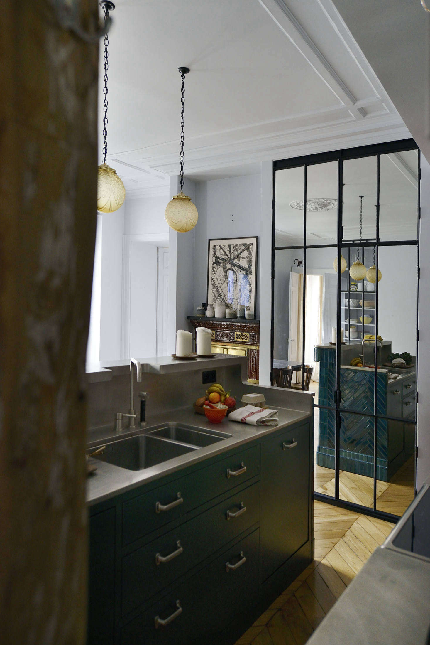The sink was custom made by Etains e Lyon, which specializes in classic all-metal sinks and counters. Linde sourced the industrial brushed stainless steel pulls online: they