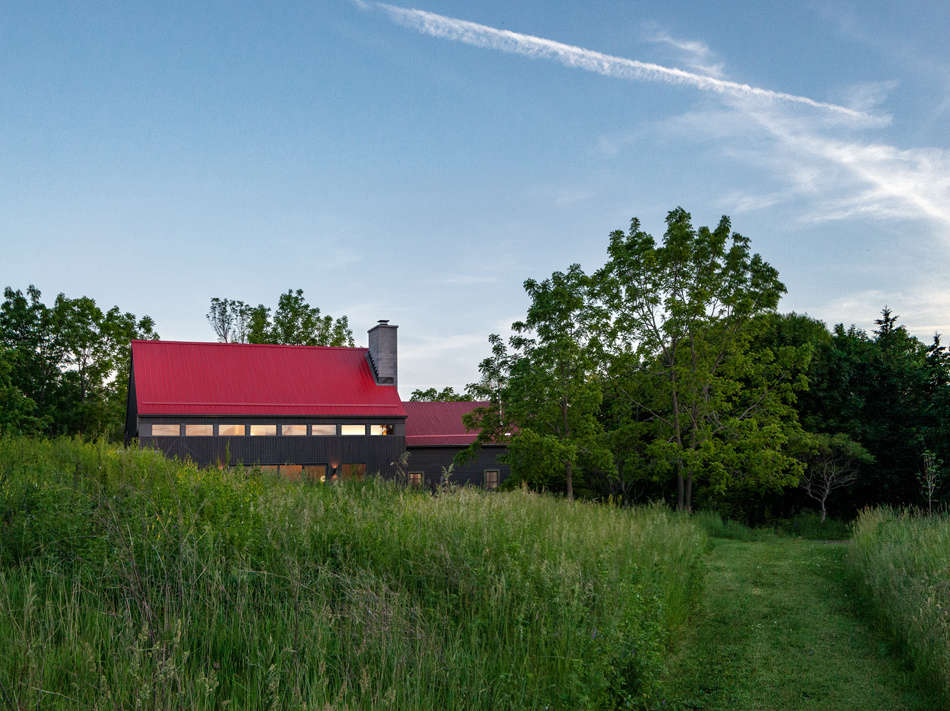 The large new addition connects to the original smaller farmhouse. 