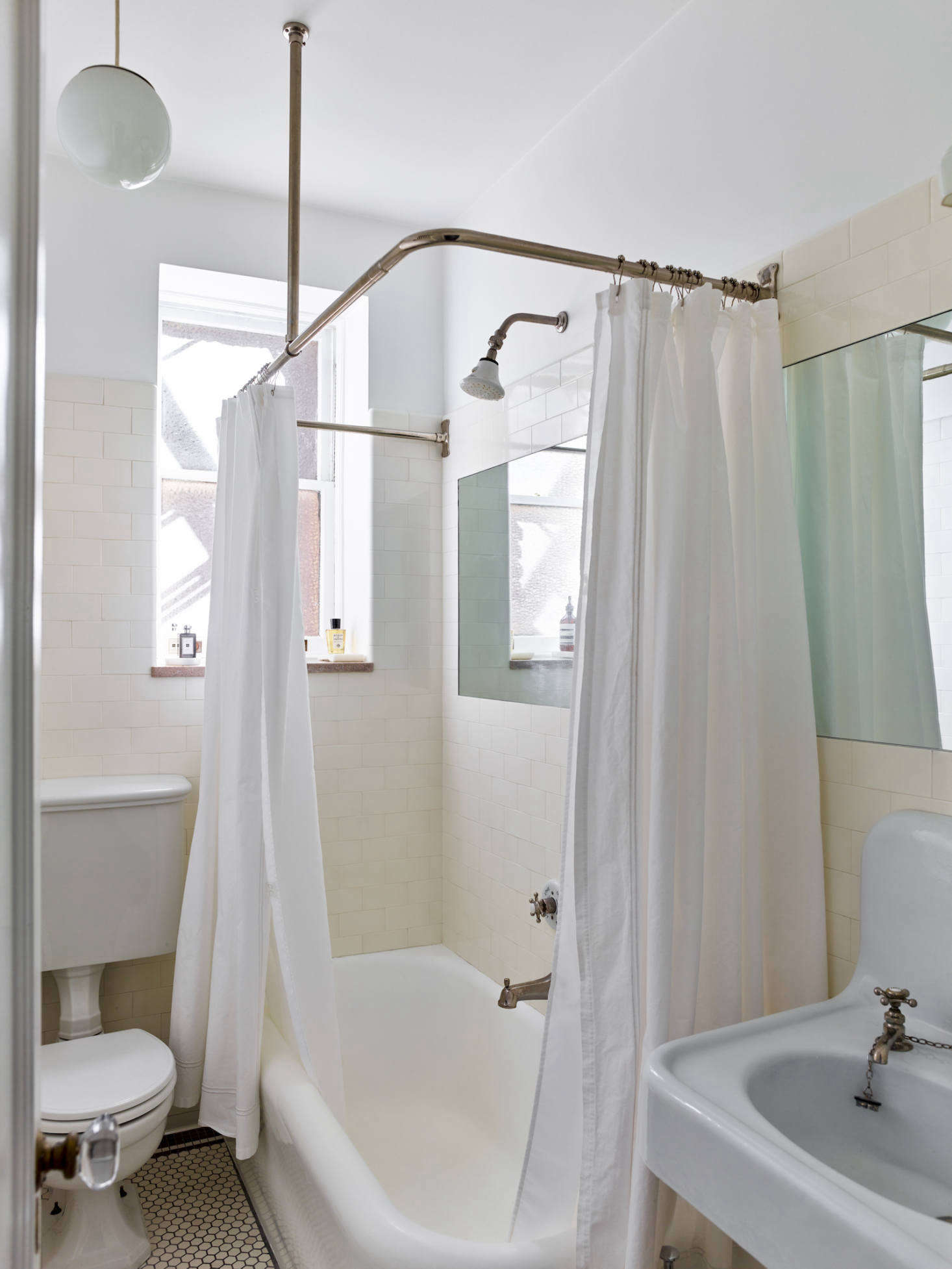 Not just for furniture: Creative director Matthew Axe trolled eBay and antiques dealers to source the period-appropriate sink, toilet, and bathroom hardware in his New York bathroom. Photograph by Eric Piasecki, from Quiet, Please: A Stylish Apartment in Bustling Jackson Heights, Queens.